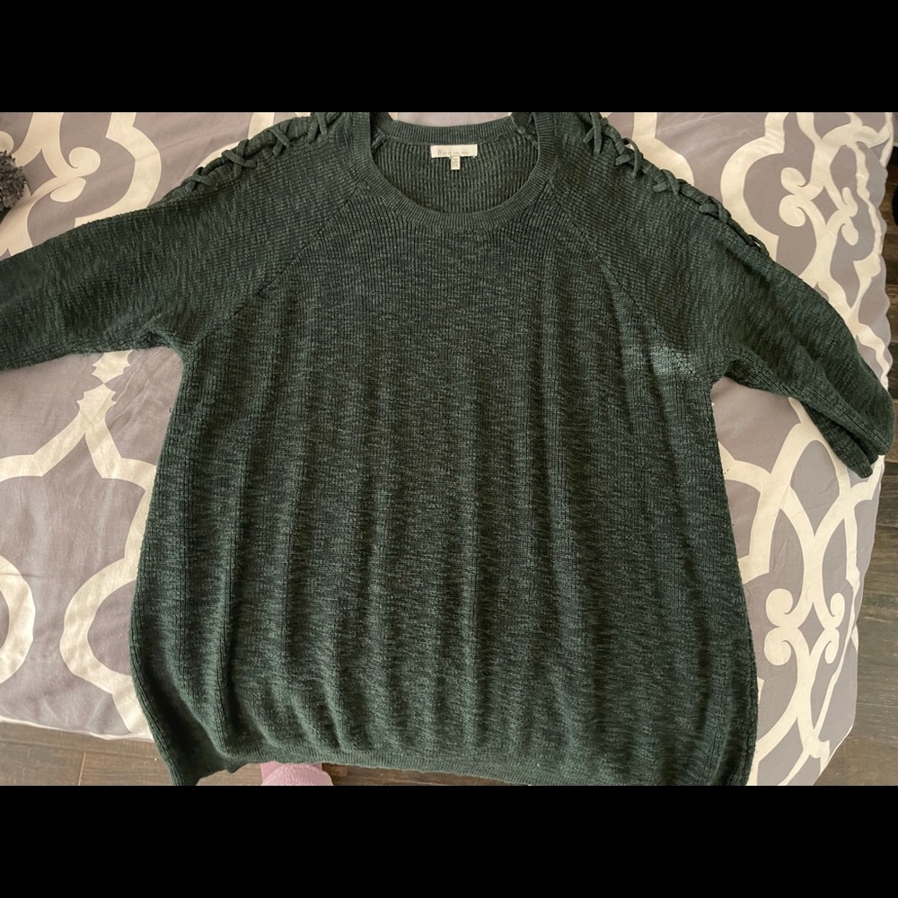 Soft green sweater with cross sleeve detail